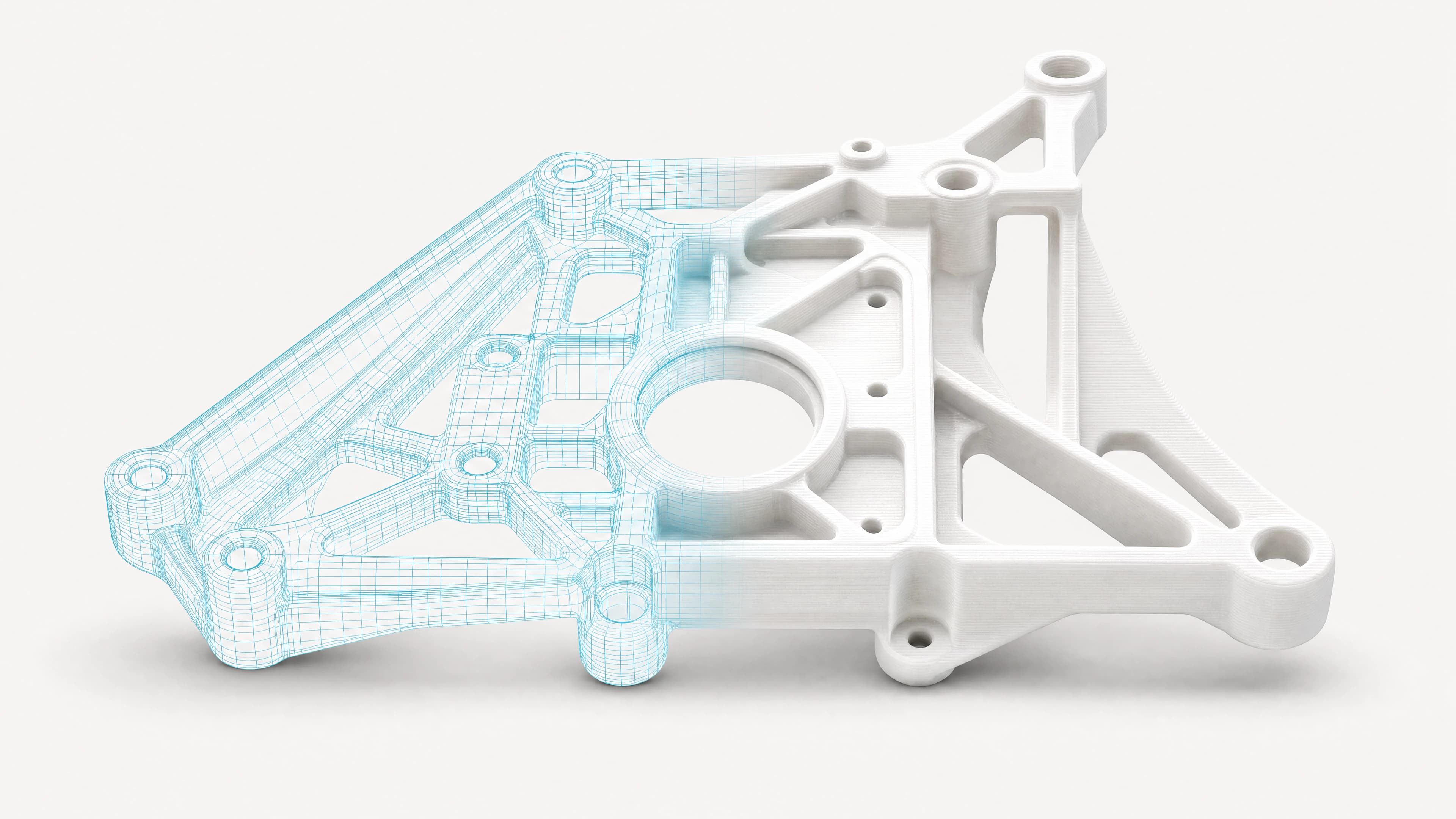 A CAD wireframe and printed version of the same mechanical part.